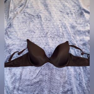 Two bras; one all black and the other pink with cheetah print